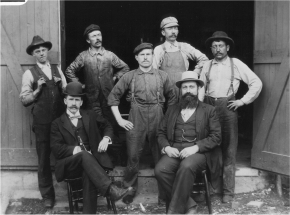 Historical photo of a group of brewers standing outside the original Columbia Brewing Co building.